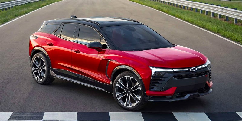 An image of a red Chevy Blazer EV sitting on a racetrack, ready to go. 