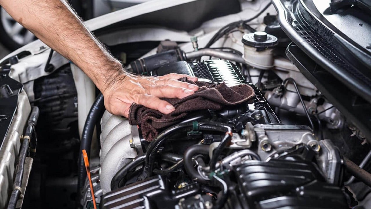 A mechanic working on a car engine